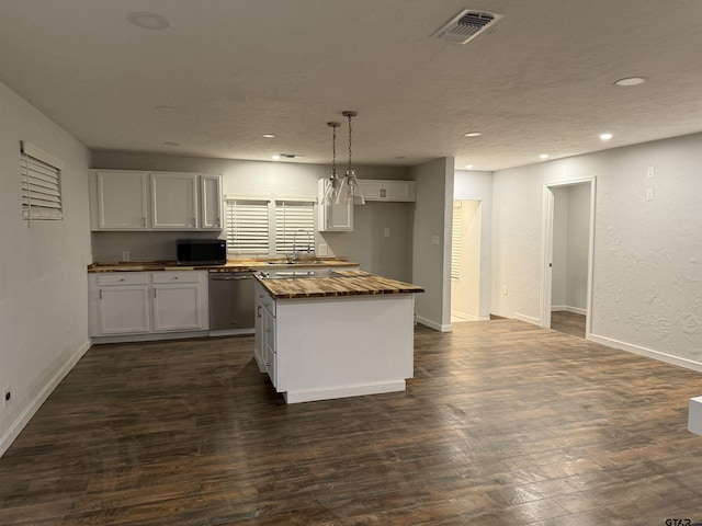 kitchen with dishwasher, a kitchen island, dark hardwood / wood-style flooring, decorative light fixtures, and white cabinets