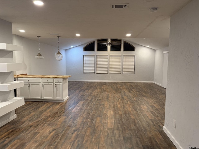 unfurnished living room with dark hardwood / wood-style flooring, ceiling fan, and lofted ceiling