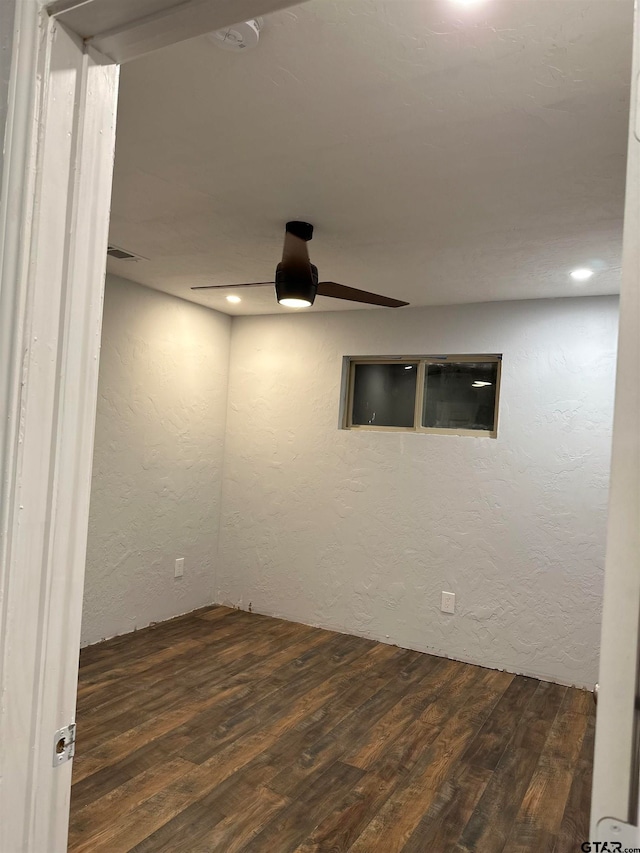 unfurnished room featuring dark hardwood / wood-style floors and ceiling fan