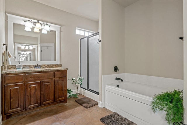 bathroom with vanity and shower with separate bathtub