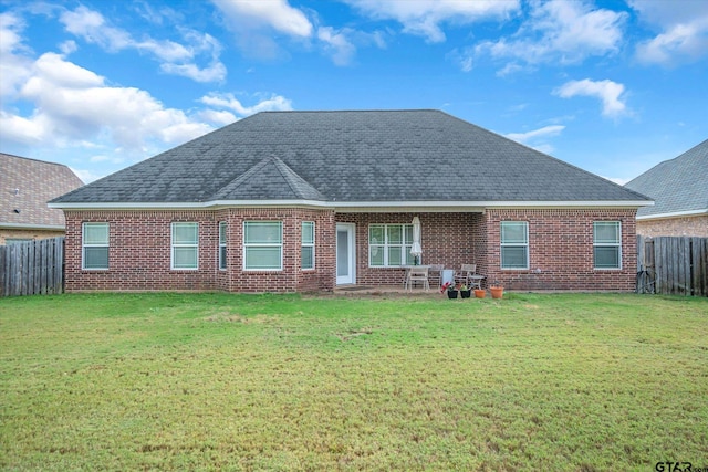 rear view of house with a lawn