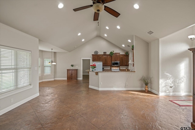 unfurnished living room with ceiling fan with notable chandelier and lofted ceiling