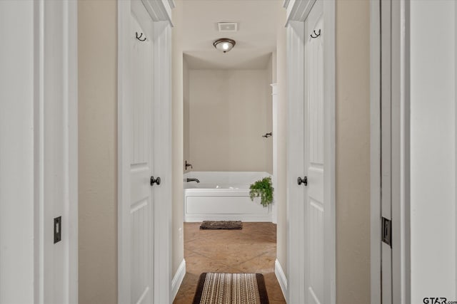 hall with tile patterned flooring