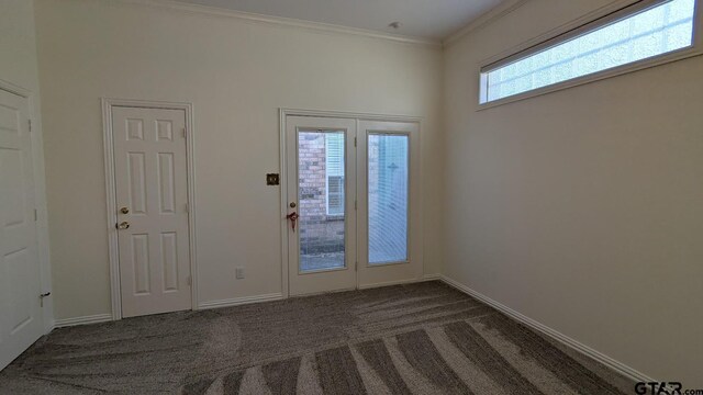 1173 Garden Park Cir, Tyler, TX 75703 - doorway with dark carpet, crown molding, and baseboards