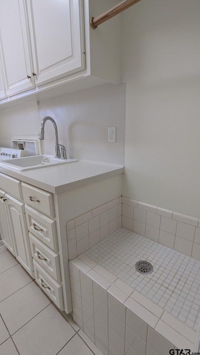 1173 Garden Park Cir, Tyler, TX 75703 - kitchen featuring a sink, white cabinetry, light tile patterned floors, and light countertops