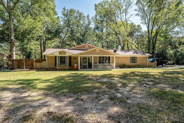 ranch-style house with a front yard and covered porch