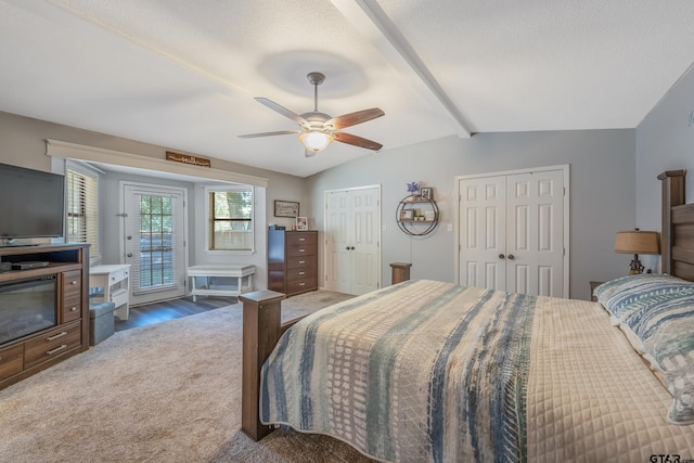 carpeted bedroom with vaulted ceiling with beams, two closets, ceiling fan, and a textured ceiling