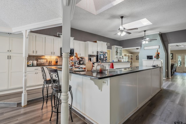 kitchen with white cabinets and a textured ceiling