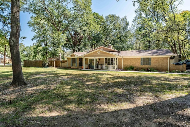 ranch-style home featuring a porch and a front yard