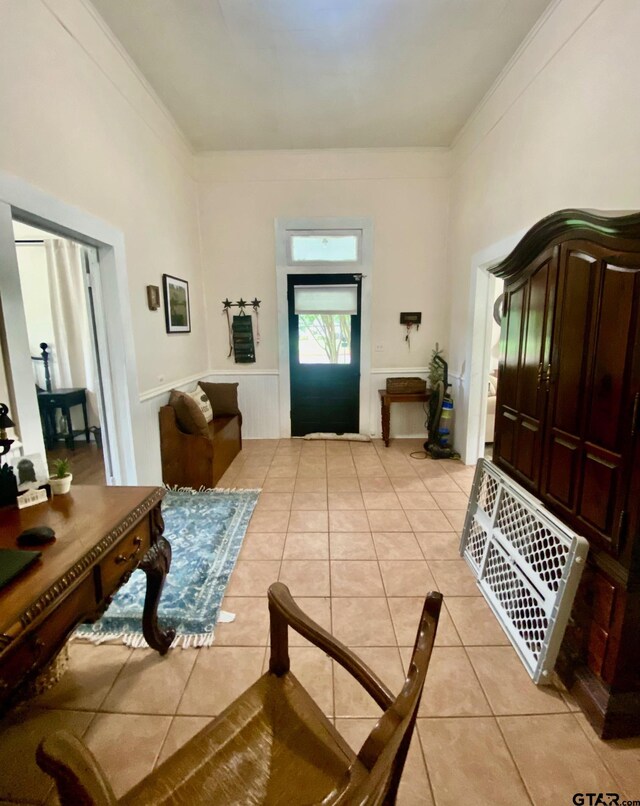 138 S Grace St, Crockett, TX 75835 - entryway featuring light tile patterned floors, crown molding, and wainscoting