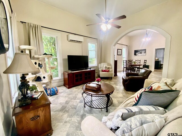 138 S Grace St, Crockett, TX 75835 - living area featuring arched walkways, a wall unit AC, healthy amount of natural light, and ceiling fan