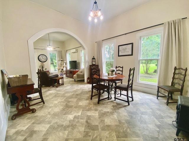 138 S Grace St, Crockett, TX 75835 - dining room with arched walkways, stone finish floors, and a ceiling fan