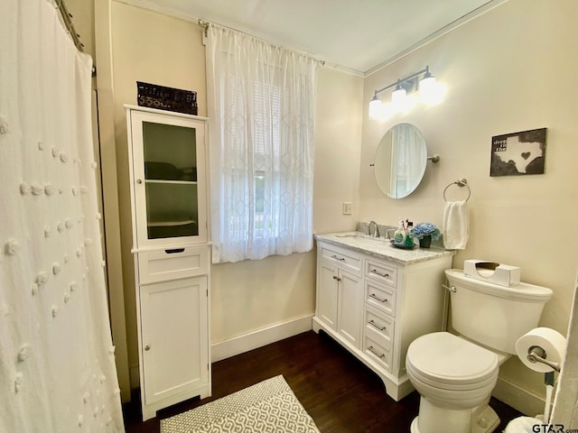 138 S Grace St, Crockett, TX 75835 - bathroom with vanity, baseboards, wood finished floors, and toilet