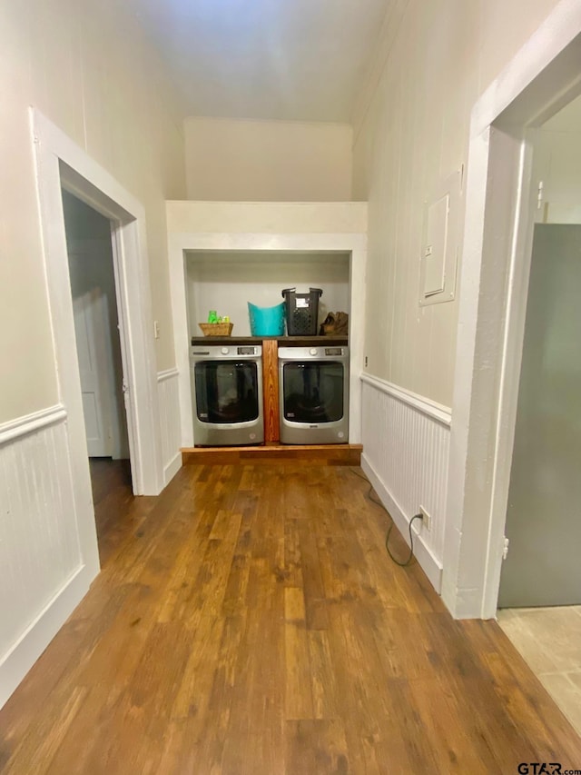 138 S Grace St, Crockett, TX 75835 - corridor with washing machine and clothes dryer, wood finished floors, wainscoting, and electric panel