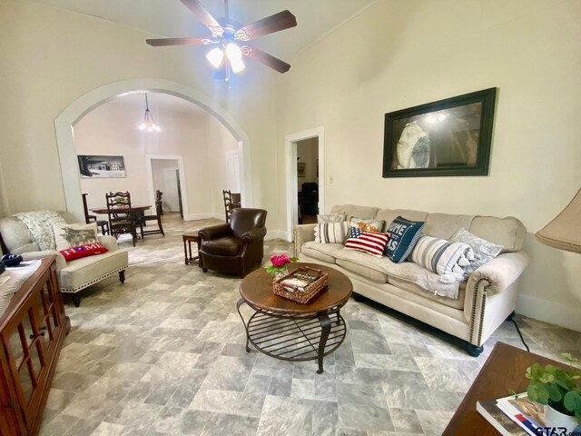 138 S Grace St, Crockett, TX 75835 - living area featuring arched walkways, ceiling fan, stone finish floors, and vaulted ceiling