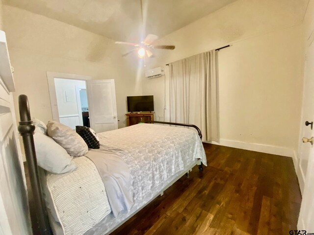 138 S Grace St, Crockett, TX 75835 - bedroom with a wall unit AC, wood finished floors, baseboards, and ceiling fan