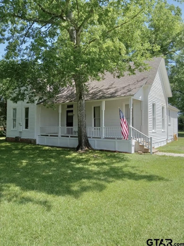 138 S Grace St, Crockett, TX 75835 - view of front of house featuring a porch, a shingled roof, and a front yard