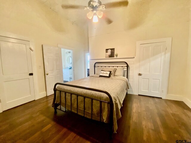 138 S Grace St, Crockett, TX 75835 - bedroom with dark wood-type flooring, vaulted ceiling, ceiling fan, and baseboards