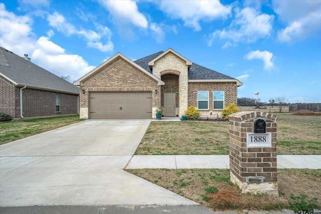 view of front of property featuring a garage and a front lawn