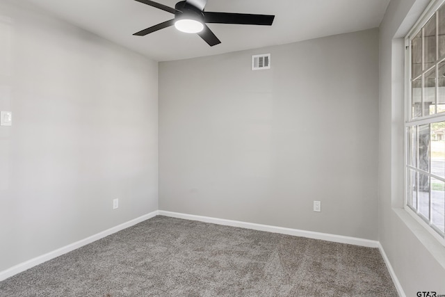 carpeted empty room featuring ceiling fan