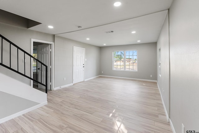 unfurnished room with light wood-type flooring