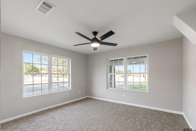 empty room with ceiling fan, carpet floors, and a healthy amount of sunlight