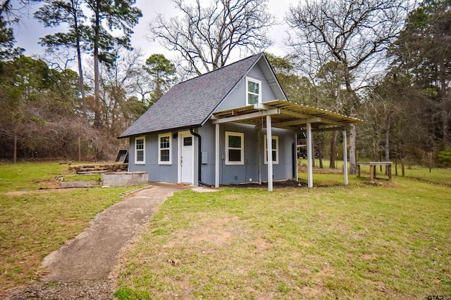 view of front of house with a shingled roof and a front yard