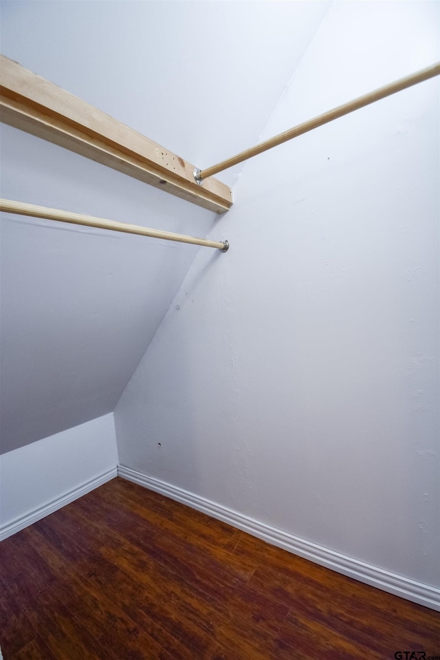 walk in closet featuring lofted ceiling and wood finished floors