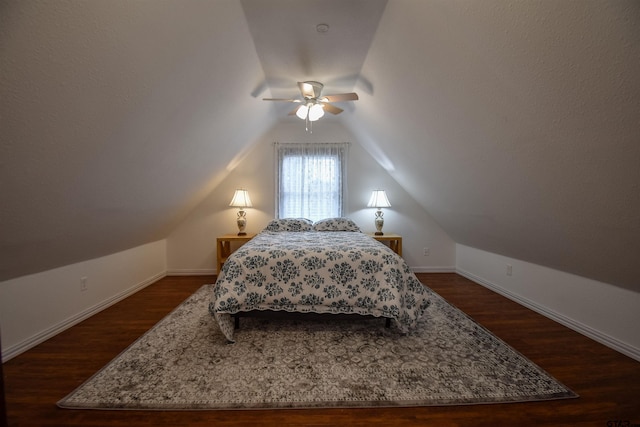 bedroom featuring a ceiling fan, vaulted ceiling, dark wood finished floors, and baseboards