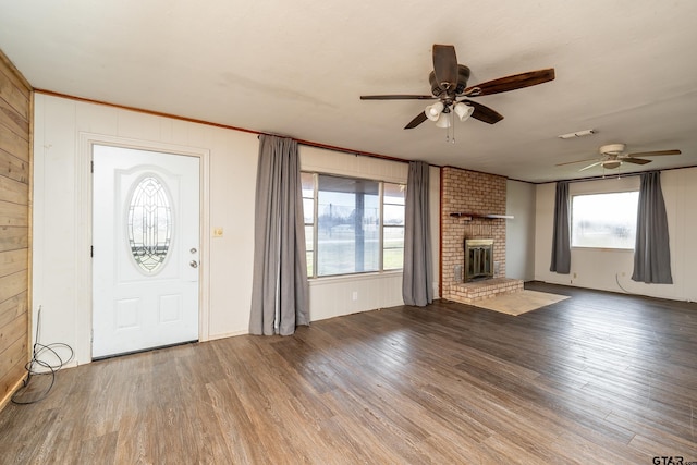 311 S Houston St, Bullard, TX 75757 - foyer entrance with hardwood / wood-style floors, a fireplace, and wood walls