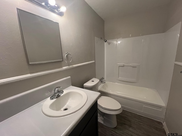 314 S Center St, Longview, TX 75601 - full bathroom with wood finished floors, vanity, toilet, and tub / shower combination