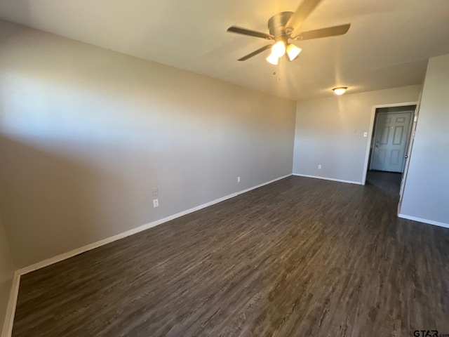 314 S Center St, Longview, TX 75601 - spare room featuring ceiling fan, dark wood-style flooring, and baseboards