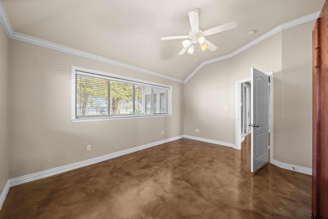 empty room with dark carpet, vaulted ceiling, ceiling fan, and crown molding