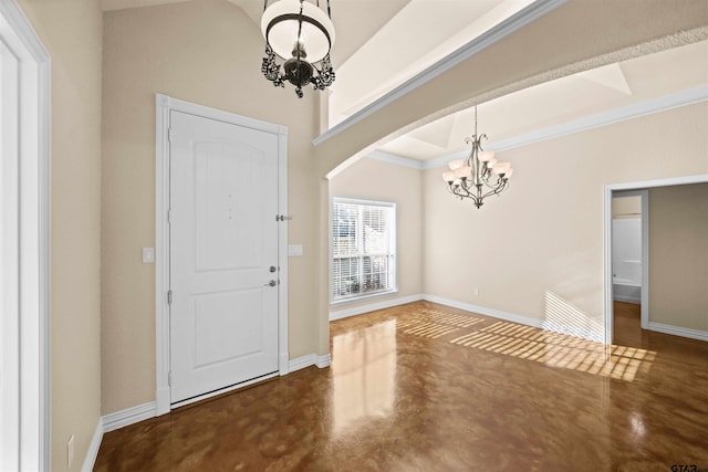 foyer entrance featuring a chandelier and crown molding