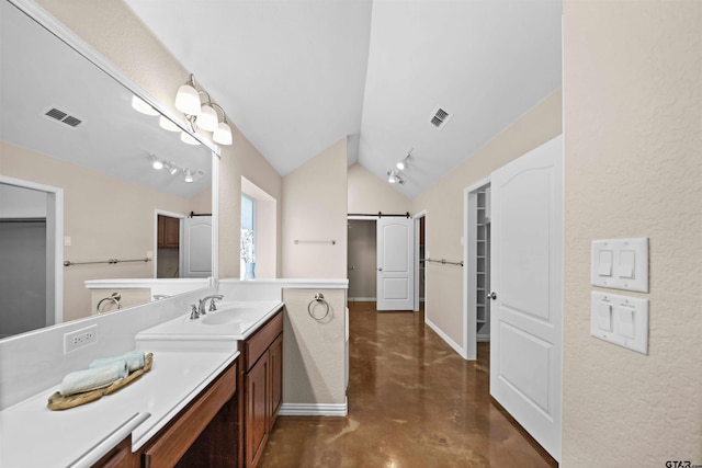 bathroom featuring vanity, concrete floors, and lofted ceiling