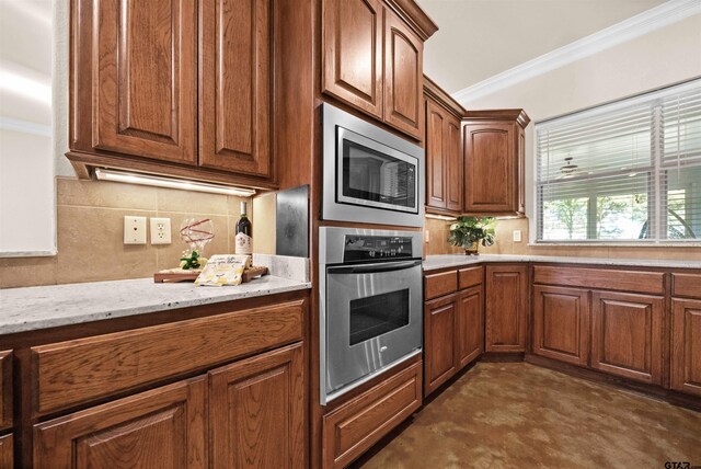 kitchen with decorative backsplash, light stone countertops, ornamental molding, and appliances with stainless steel finishes