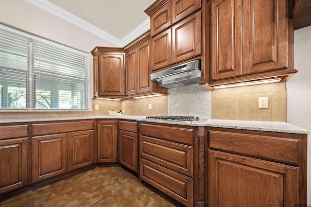 kitchen featuring light stone countertops, tasteful backsplash, ornamental molding, stainless steel gas cooktop, and exhaust hood