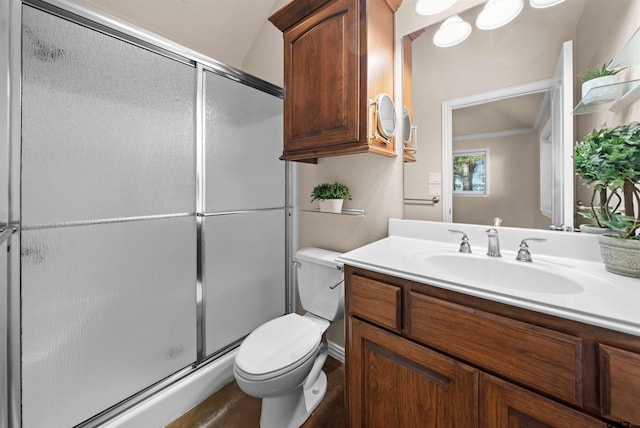 bathroom with a shower with door, vanity, and toilet