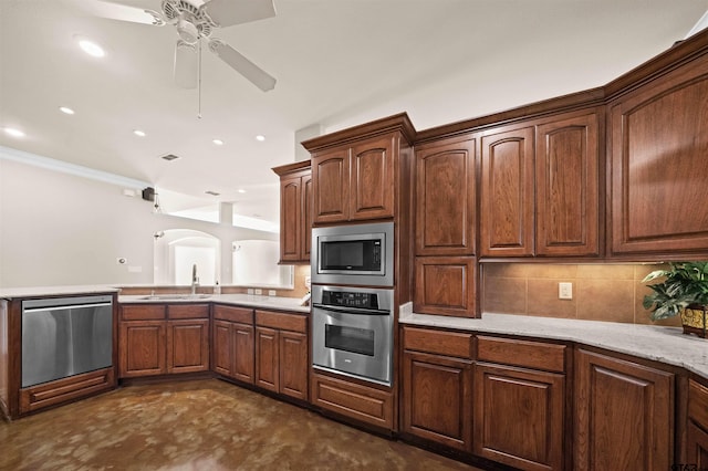 kitchen with crown molding, sink, ceiling fan, tasteful backsplash, and stainless steel appliances