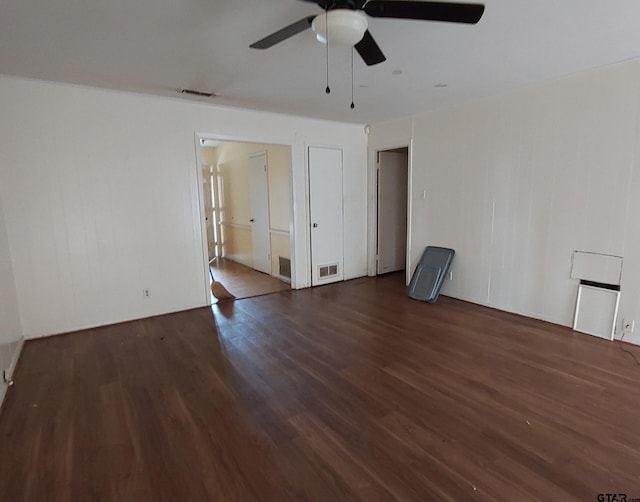 spare room with visible vents, ceiling fan, and wood finished floors