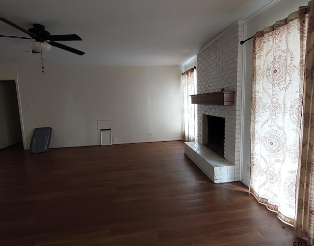 unfurnished living room with a ceiling fan, a fireplace, and wood finished floors