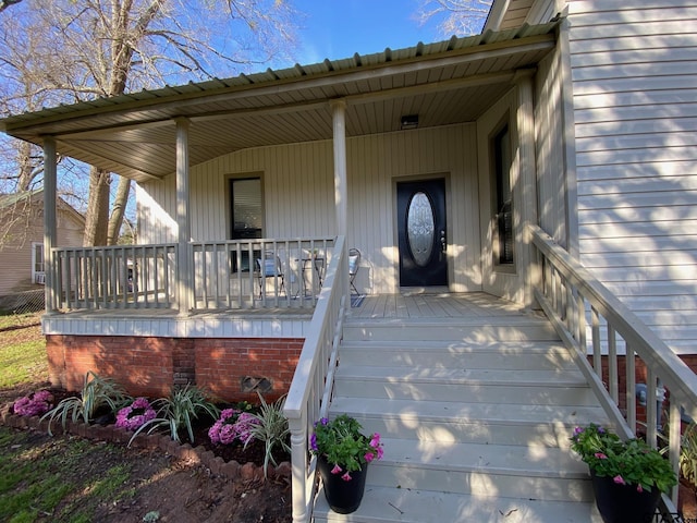 view of exterior entry featuring a porch