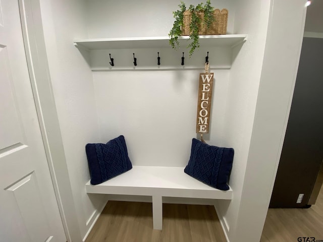 mudroom with wood finished floors and baseboards