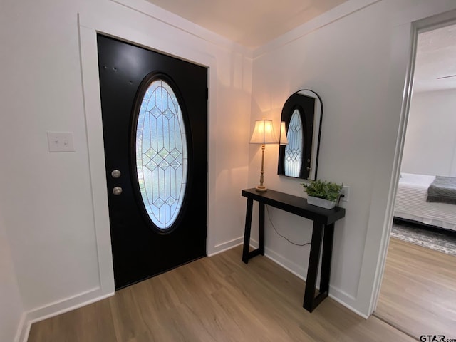 entrance foyer with light wood-style flooring and baseboards