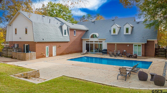 back of house featuring a patio and a lawn