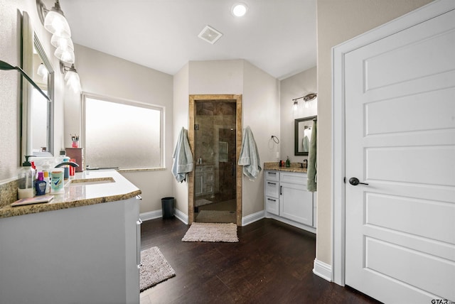 bathroom featuring an enclosed shower, wood-type flooring, and vanity