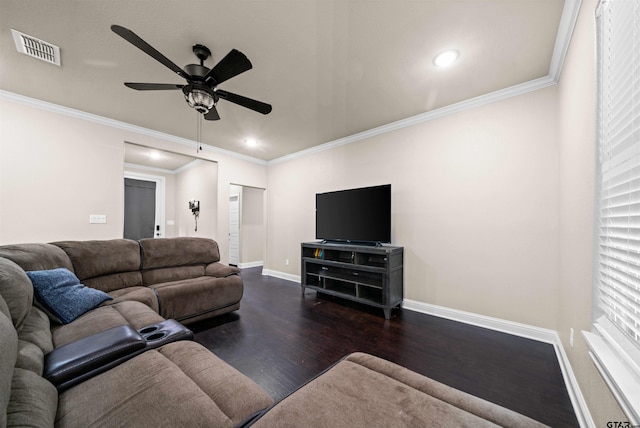 living room with dark wood-type flooring, ceiling fan, and crown molding