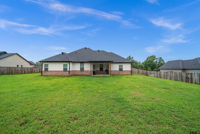 back of property with a lawn