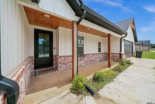 view of exterior entry with a garage