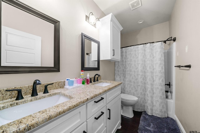 full bathroom featuring vanity, toilet, and shower / bathtub combination with curtain